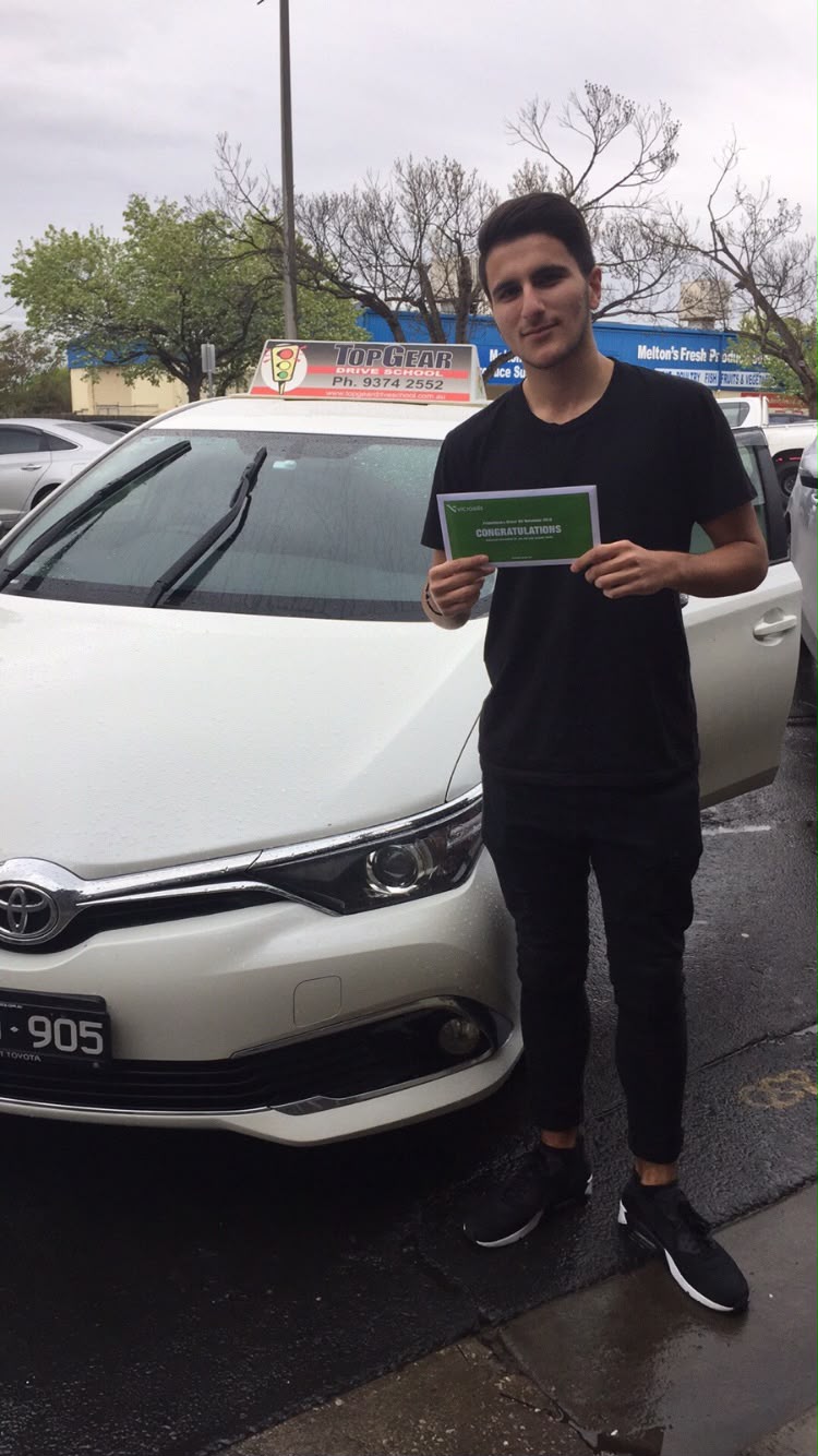 Learner driver holding their VicRoads congratulations certificate on test day